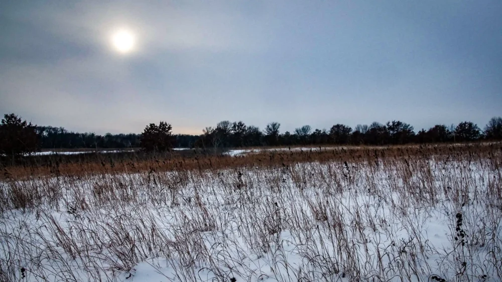 A scenic winter prairie with the sun low in the sky