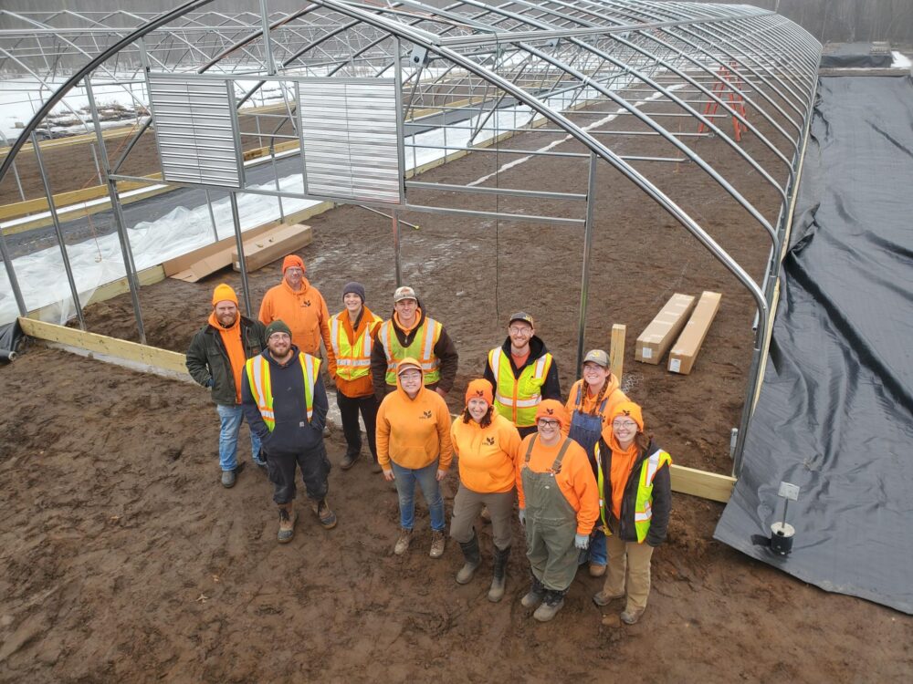 MNL team poses for a group photo during construction of greenhouses
